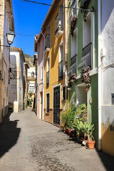 Bolulla, Alicante, Spain- February 4, 2022: Narrow Street and typical facades of Bolulla village in Alicante, Spain