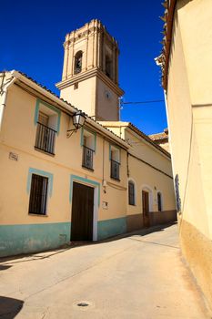 Bolulla, Alicante, Spain- February 6, 2022: Facades of Bolulla village and San Jose church tower in the background