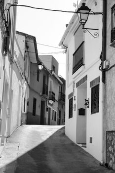 Bolulla, Alicante, Spain- February 4, 2022: Narrow Street and typical facades of Bolulla village in Alicante, Spain