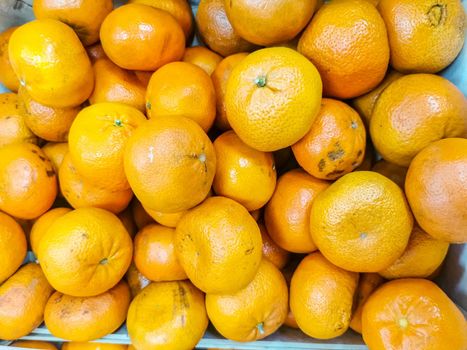 texture of oranges on market showcase.patural vitamin c pattern. artistic blur, selective focus