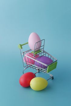 easter concept with multi color egg with a shopping art on color background .