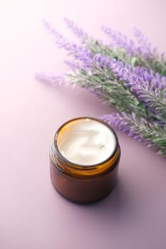 herbal cream cosmetic in a container on table