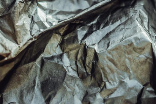 Abstract real paper surface background. Aluminum Platinum Silver foil. Wrinkled crumpled folds bend crush crease kink. Crystal, polygonal texture wave futurism 80s retro style new year. Gray tone.