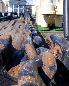 Large iron anchor chain. A rusty chain link. Corrosion.