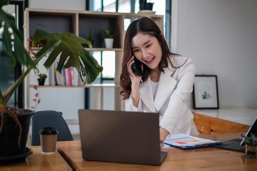 Asian Businesswoman or Accountant hands holding paperwork with calculator, account and saving concept