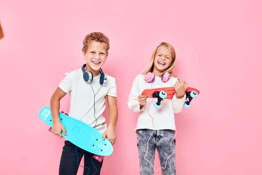 Children riding skateboard are playing together isolated background. High quality photo