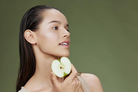 portrait woman apple in hands posing fruit healthy food fresh green background. High quality photo