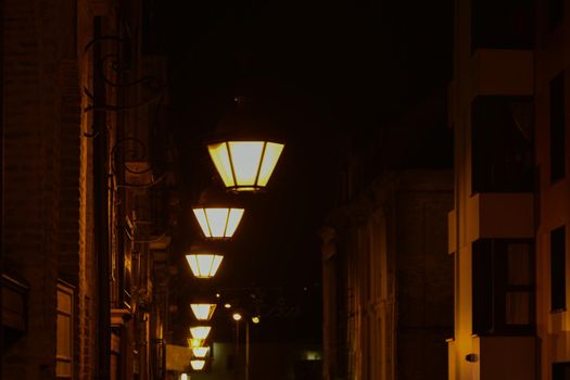 Vintage lamps shine on the street at night