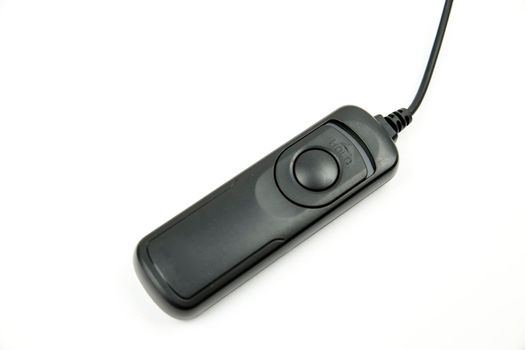 Black remote shutter release on white background