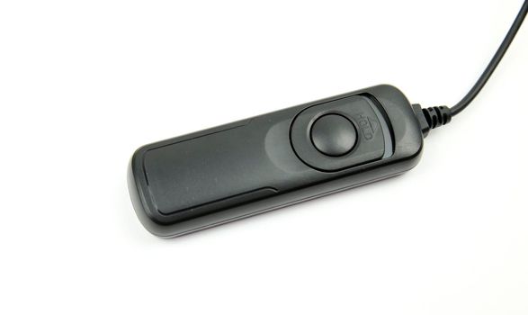 Black remote shutter release on white background