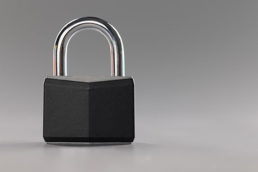 Close-up of solid metal locked padlock, thing to protect home or apartment with, protection from break in. Safety, security, padlock concept. Copy space