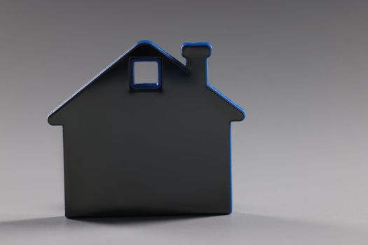 Close-up of miniature house toy, symbol for real estate and accommodation, rent or buy apartment, invest in property. Housing, household, rental concept