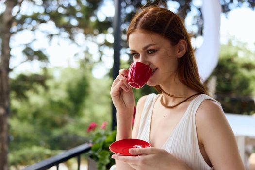 Young stylish woman drinking coffee outdoors unaltered. High quality photo