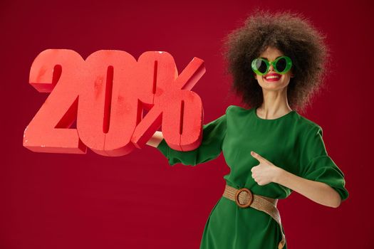 pretty woman holding red twenty percent discount advertising red background unaltered. High quality photo