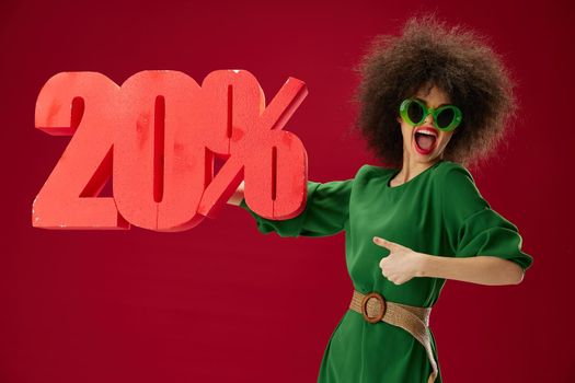 Beauty Fashion woman green dress afro hairstyle dark glasses twenty percent in hands color background unaltered. High quality photo