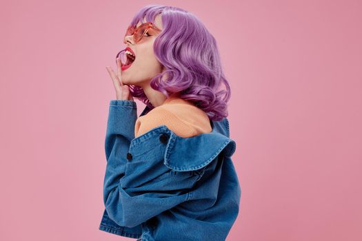 Beauty Fashion woman purple hair fashion glasses denim clothing pink background unaltered. High quality photo