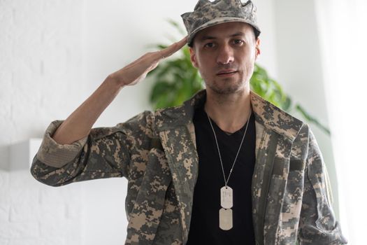 Photo of soldier in camouflaged uniform close-up view