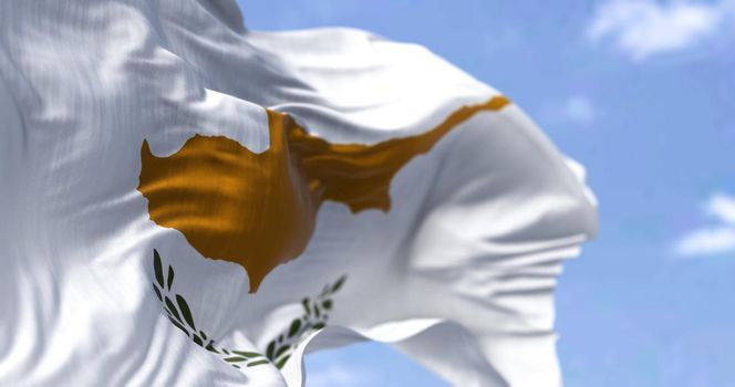 Detail of the national flag of Cyprus waving in the wind on a clear day. Cyprus is an island country in the eastern Mediterranean Sea. Patriotism. Selective focus.