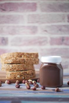 Chocolate Hazelnut cream in a container on table .