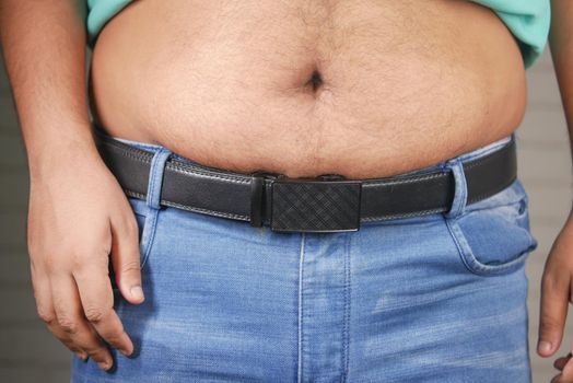 man with excessive belly fat, overweight concept.