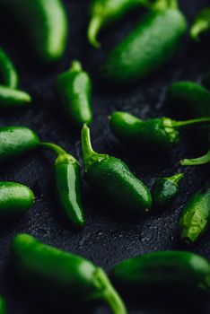 Green Jalapeno Peppers on Dark Concrete Background