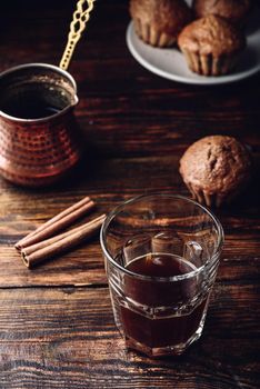 Turkish coffee with spices and oatmeal muffins on wooden surface