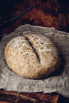 Freshly baked loaf of rye bread on cutting board