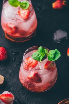 Cocktail with fresh and frozen strawberries, vodka and soda in glasses