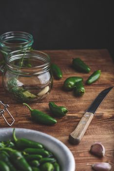 Jalapeno Peppers for Canning, Spices, Garlic and Glass Jars on Wooden Table. Copy Space