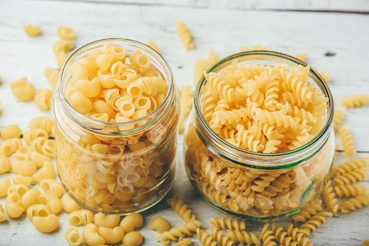 Two kinds of Italian whole wheat pasta in glass jars