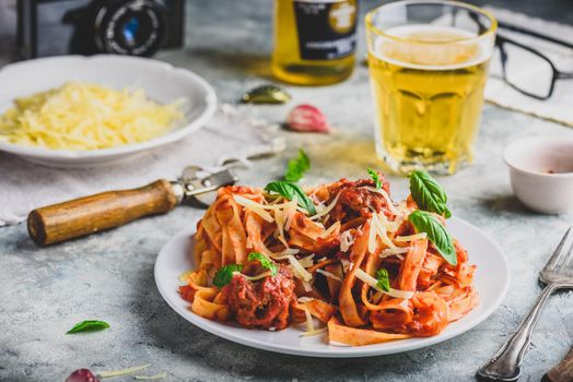 Pasta with mini meatballs, tomato sauce and parmesan cheese