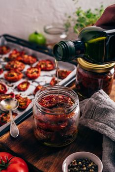 Tomato Preserves with Thyme and Garlic in Olive Oil in a Glass Jar