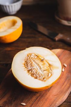 Half of Sweet Yellow Melon on Cutting Board