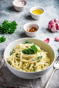 Easy lunch recipe. Linguine pasta with olive oil, garlic, fresh parsley and grated parmesan cheese.