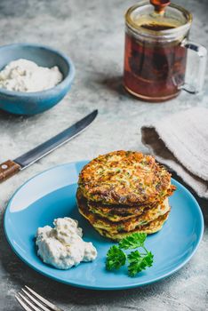 Zucchini parmesan pancakes with dip and parsley