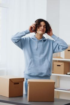 portrait of a man unpacking things from boxes in the room interior. High quality photo