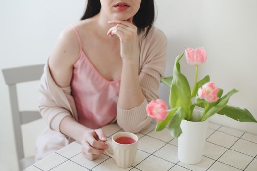 romantic tender portrait of a young woman with pink fresh tulips