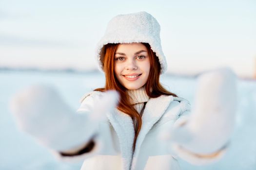 woman in a white coat in a hat winter landscape walk Fresh air. High quality photo