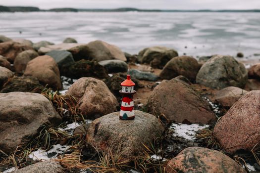 Frozen winter sea with decorative lighthouse. Nautical lifestyle. Winter, Sea, Travel, adventure, holidays and vacation concept. Travel in 2021.