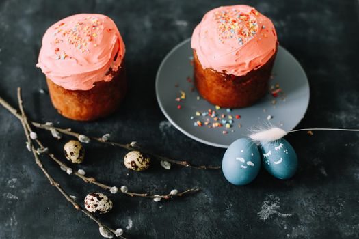 Easter cakes with decorations, colorful eggs and willow branches. Happy Easter holiday concept