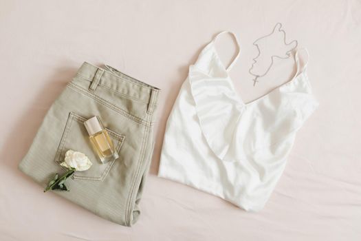 Women silk lingerie on beige background top view, flatlay. Female lace nightwear clothes. 