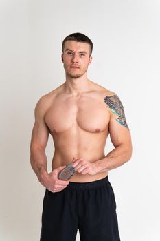 Male drink-water fitness is pumped with a towel on a white background isolated fitness lifestyle, sport male adult sportive, sporty athletic. Towel powerful one muscle