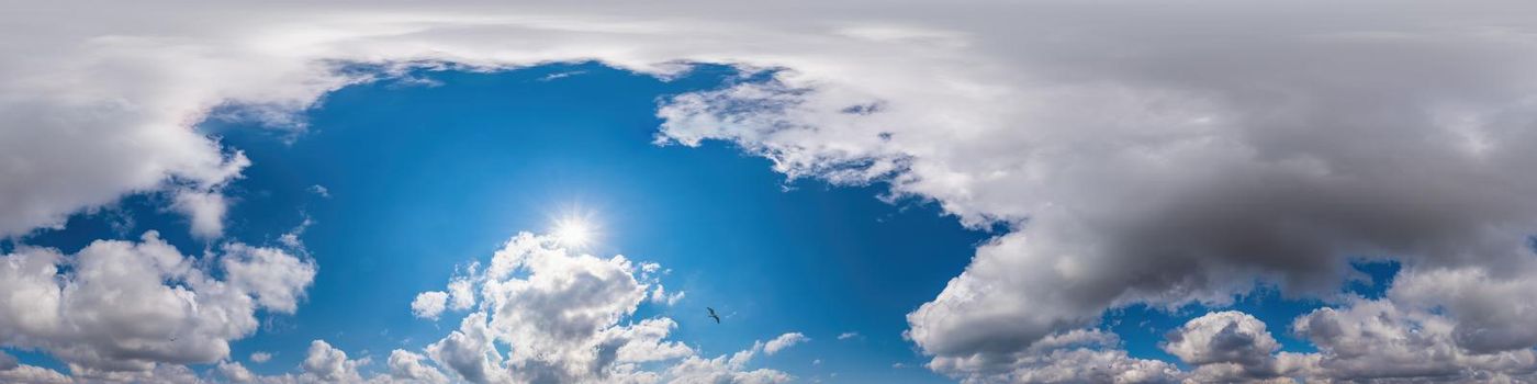 Blue evening sky Seamless spherical equirectangular panorama 360-degree view with beautiful Stratocumulus clouds, setting sun - for use in 3D graphics as a sky dome or post-processing of drone images.