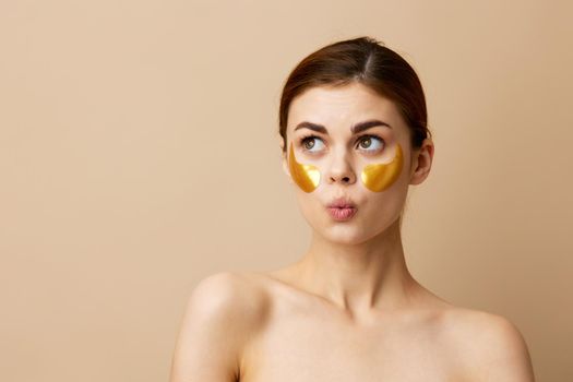 woman golden patches on the face isolated background. High quality photo