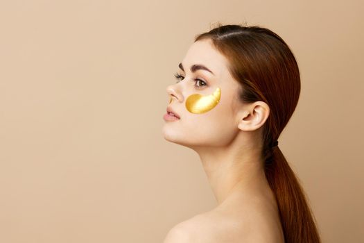 beautiful woman skin care face patches bare shoulders hygiene isolated background. High quality photo