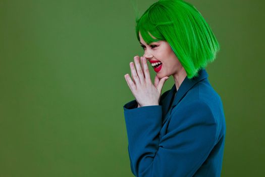 Portrait of a charming lady Glamor green wig red lips blue jacket green background unaltered. High quality photo
