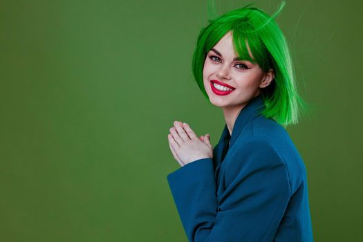 Pretty young female attractive look green wig blue jacket posing green background unaltered. High quality photo