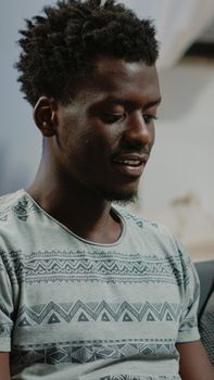 Close up of black person typing on laptop keyboard enjoying free time after remote work. African american entrepreneur using device for online communication while browsing internet.