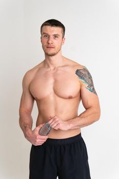 Male drink-water fitness is pumped with a towel on a white background isolated athlete water healthy male man holding, sporty copy pace, thirsty one muscle