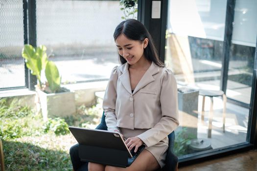 Asian business woman having video call with business team to consult about business plan of company. Online team meeting video conference